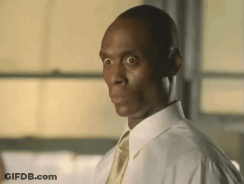 A Man Wearing A White Shirt And Tie Is Making A Funny Face . GIF