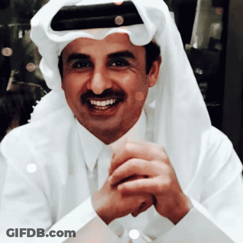 A Man Wearing A White Shirt And Tie Is Smiling GIF
