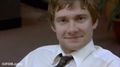 A Man Wearing A White Shirt And Tie Is Smiling . GIF