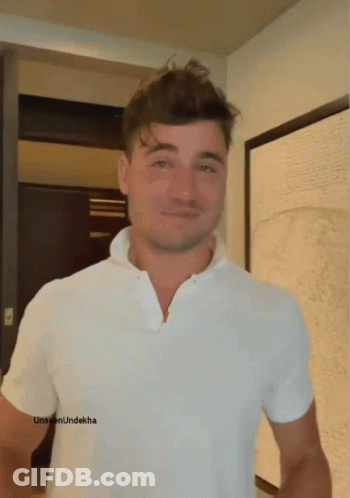 A Man Wearing A White Shirt Has The Word Unseen Underkha On The Bottom Of His Shirt GIF