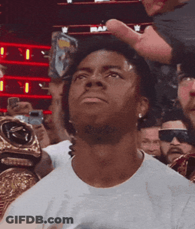 A Man Wearing A White Shirt Is Looking Up At The Sky GIF