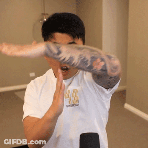 A Man Wearing A White Shirt That Says 40Th Anniversary On It GIF