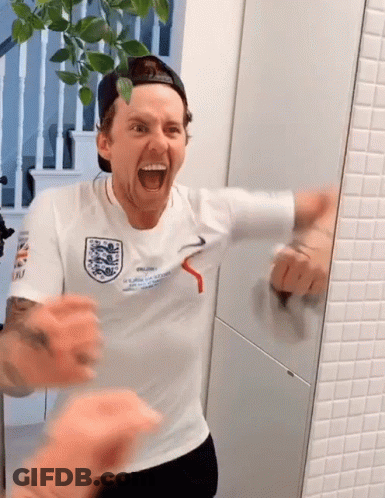 A Man Wearing A White Shirt That Says " England " On It GIF