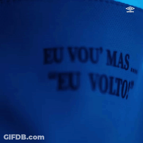 A Man Wearing A White Shirt That Says " Eu Vou " On The Collar GIF