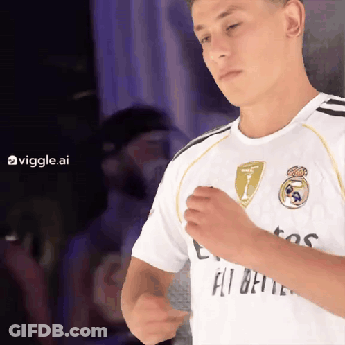 A Man Wearing A White Shirt That Says Fly Emirates On It GIF