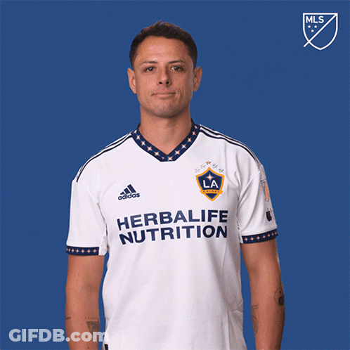 A Man Wearing A White Shirt That Says Herbalife Nutrition Is Pointing Up GIF