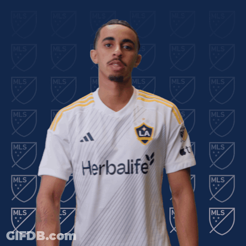 A Man Wearing A White Shirt That Says Herbalife On It GIF
