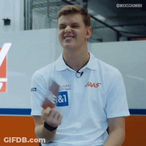 A Man Wearing A White Shirt That Says ' Hnas ' On It GIF