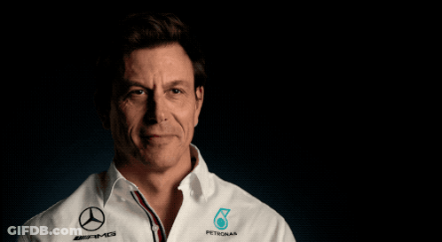 A Man Wearing A White Shirt That Says Petronas GIF