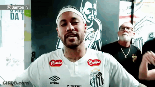 A Man Wearing A White Shirt That Says Umbro On The Front GIF
