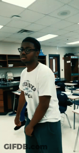 A Man Wearing A White Shirt That Says United States Of America GIF