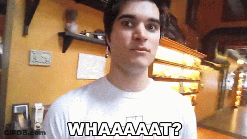 A Man Wearing A White Shirt That Says Whaaaaat GIF