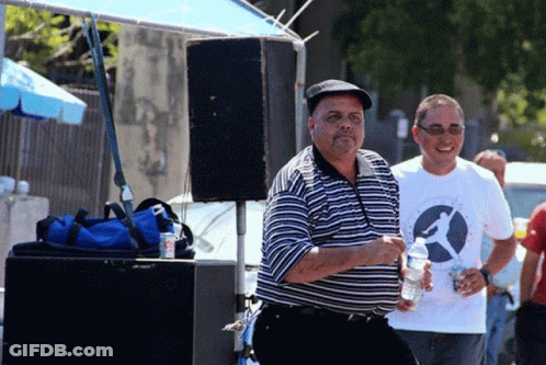 A Man Wearing A White Shirt With A Bird On It Holds A Bottle Of Water GIF