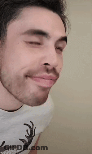A Man Wearing A White Shirt With A Deer On It GIF