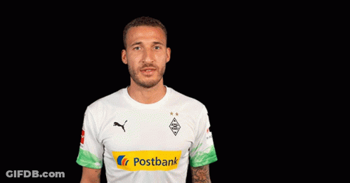 A Man Wearing A White Shirt With A Postbank Logo On The Sleeve GIF