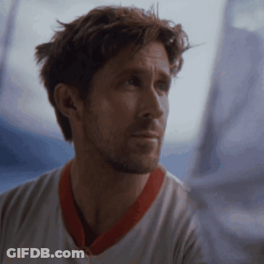 A Man Wearing A White Shirt With A Red Collar Looks Out A Window GIF