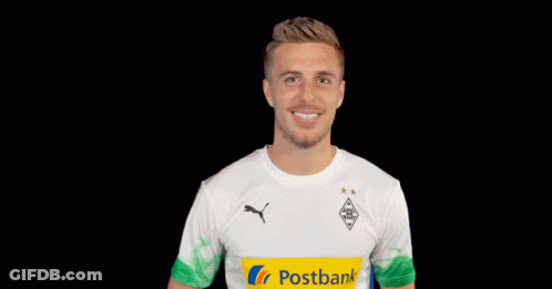 A Man Wearing A White Shirt With A Yellow Postbank Logo On It GIF