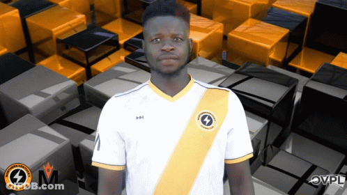 A Man Wearing A White Shirt With A Yellow Stripe And A Lightning Bolt On The Front GIF
