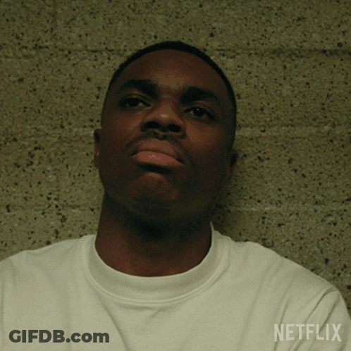 A Man Wearing A White Shirt With Netflix Written On The Sleeve GIF