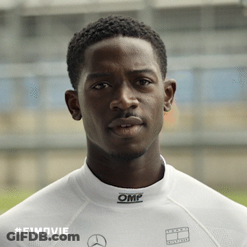 A Man Wearing A White Shirt With Omp On The Collar GIF