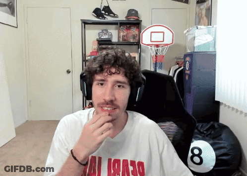 A Man Wearing A White Shirt With Red Letters That Says ' Miami ' On It GIF