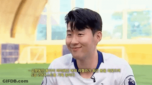 A Man Wearing A White Shirt With The Number 20 On It Smiles GIF