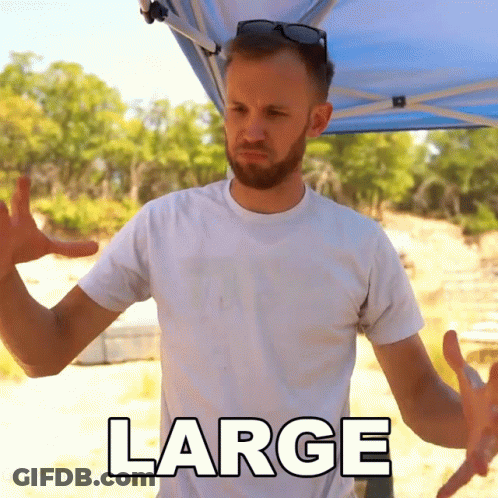 A Man Wearing A White Shirt With The Word Large On The Front GIF