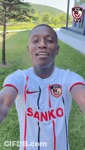 A Man Wearing A White Shirt With The Word Sanko On The Front GIF