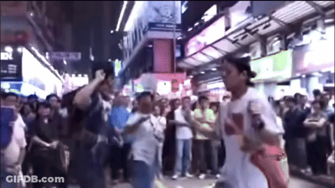 A Man Wearing A White Shirt With The Word Supreme On It Stands In Front Of A Crowd GIF
