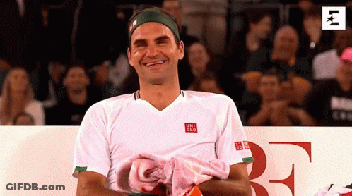 A Man Wearing A White Shirt With The Word Uniqlo On The Front GIF