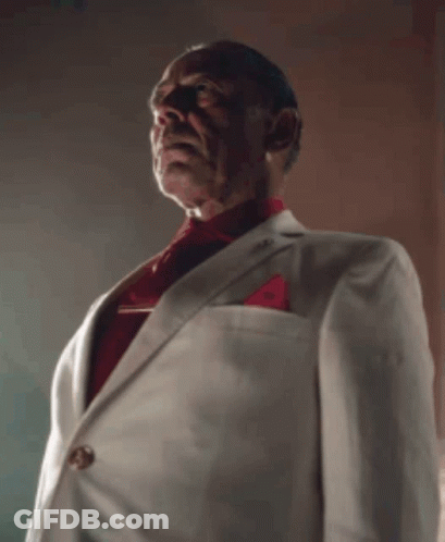 A Man Wearing A White Suit And Red Tie GIF