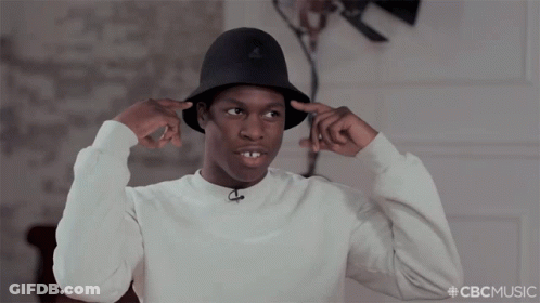A Man Wearing A White Sweater And A Black Hat With The Hashtag Cbcmusic On The Bottom GIF