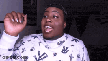 A Man Wearing A White Sweater With A Cactus Pattern On It GIF