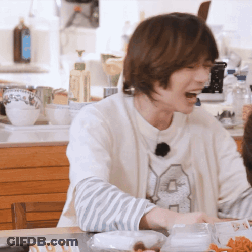 A Man Wearing A White Sweater With The Number 8 On It GIF