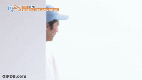 A Man Wearing A White Sweatshirt And A Blue Hat Is Smiling And Holding His Hands To His Chest . GIF