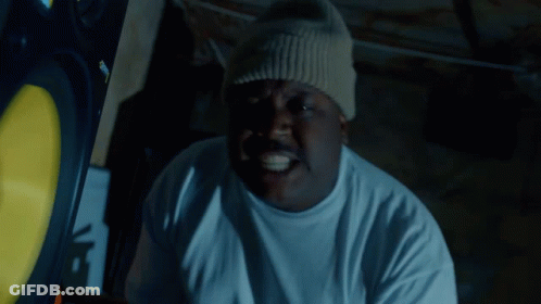 A Man Wearing A White T-Shirt And A Beanie Has A Sticker On His Hat That Says Supreme GIF