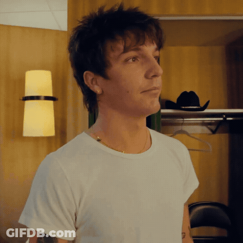 A Man Wearing A White T-Shirt And A Cowboy Hat GIF