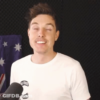 A Man Wearing A White T-Shirt Is Smiling With His Eyes Closed . GIF