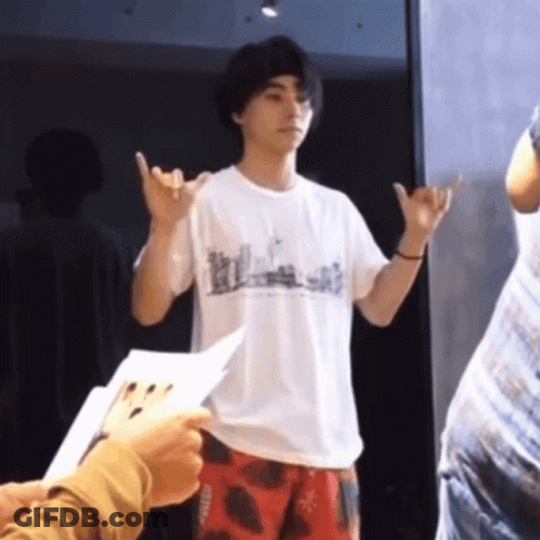 A Man Wearing A White T-Shirt That Says " Hawaii " On It GIF