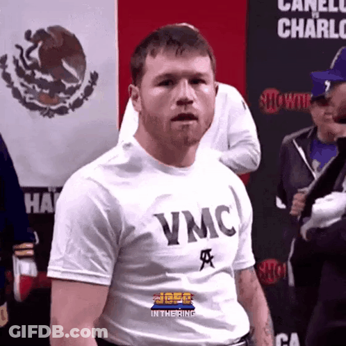 A Man Wearing A White T-Shirt That Says Vmc On It GIF