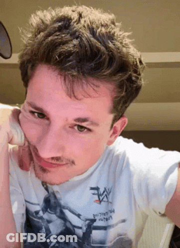 A Man Wearing A White T-Shirt That Says Wrestling On It GIF