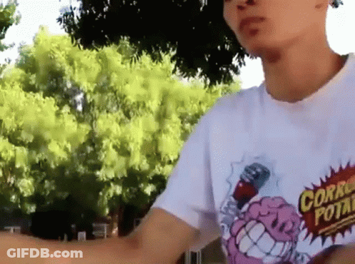 A Man Wearing A White T-Shirt With A Cartoon Brain On It GIF