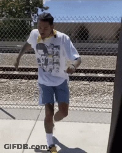 A Man Wearing A White T-Shirt With A Picture Of A Man On It GIF