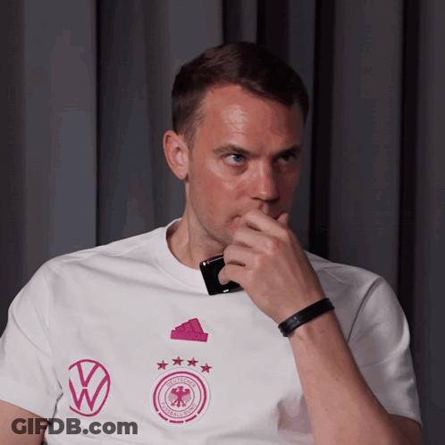 A Man Wearing A White T-Shirt With A Volkswagen Logo On It GIF