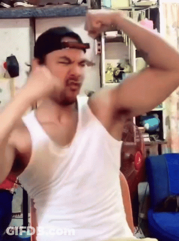 Man In White Tank Top And Cap Flexing GIF