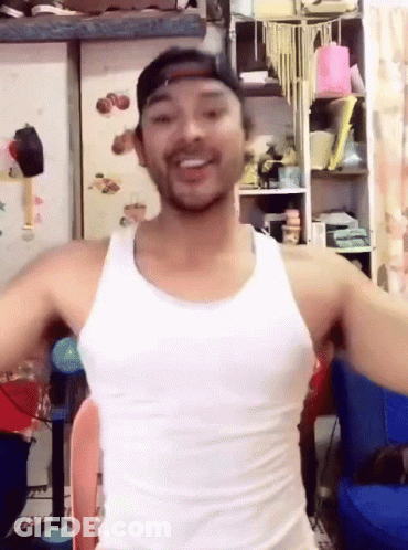 Man In White Tank Top And Baseball Cap Smiling GIF
