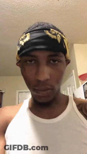 A Man Wearing A White Tank Top And A Black Headband GIF