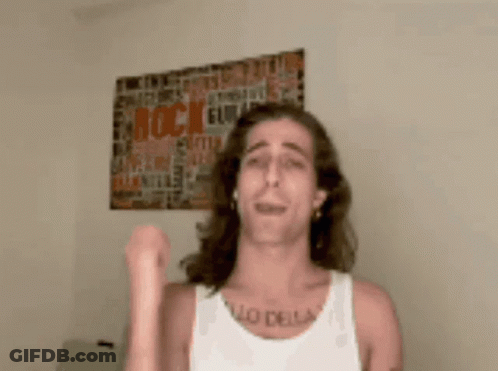 A Man Wearing A White Tank Top Has A Tattoo On His Chest That Says " Lo Della " GIF
