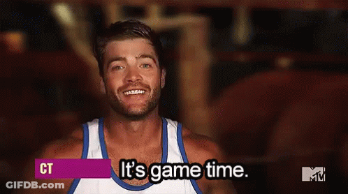 A Man Wearing A White Tank Top Is Smiling And Says It 'S Game Time . GIF
