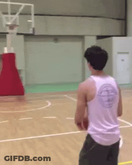 A Man Wearing A White Tank Top With A Basketball Logo On The Back Is Playing Basketball GIF